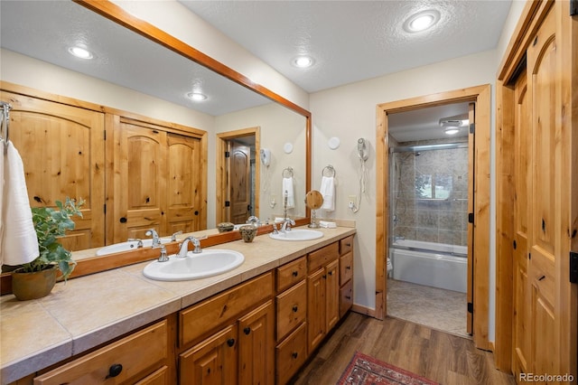 22300 US Highway 6 Unit 1746, Dillon, CO 80435 - bathroom with double vanity, wood finished floors, and bath / shower combo with glass door