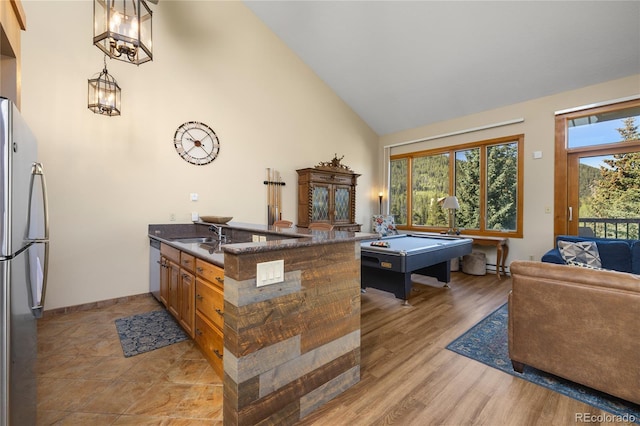22300 US Highway 6 Unit 1746, Dillon, CO 80435 - kitchen with appliances with stainless steel finishes, high vaulted ceiling, a peninsula, open floor plan, and billiards