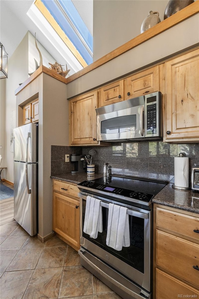 22300 US Highway 6 Unit 1746, Dillon, CO 80435 - kitchen featuring appliances with stainless steel finishes, tasteful backsplash, and dark stone countertops