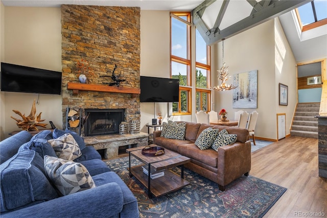 22300 US Highway 6 Unit 1746, Dillon, CO 80435 - living room featuring a chandelier, high vaulted ceiling, stairway, healthy amount of natural light, and wood finished floors