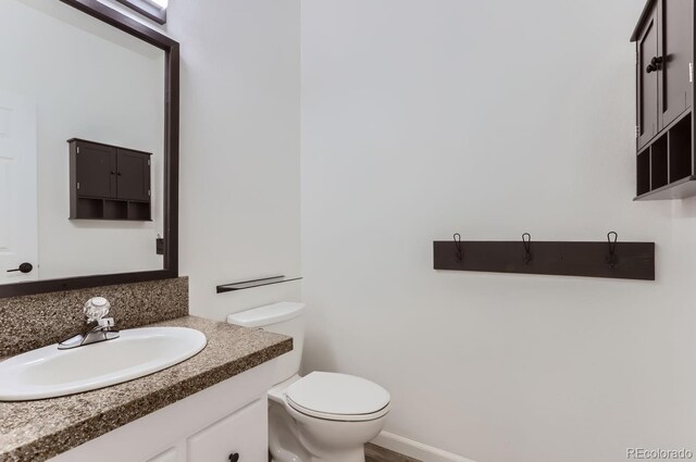 bathroom featuring toilet and vanity