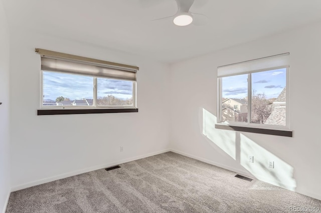 empty room featuring ceiling fan and carpet floors