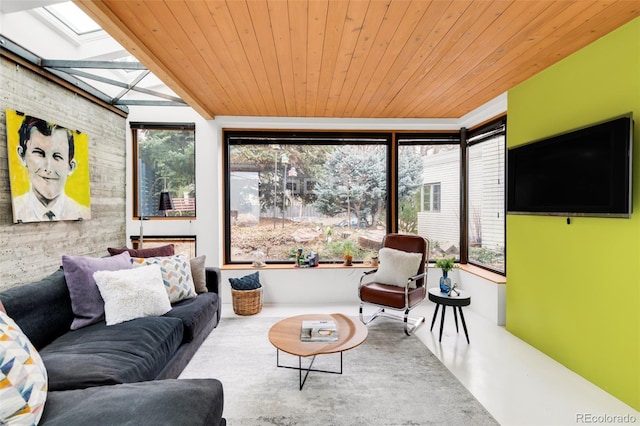 living area featuring wooden ceiling, a skylight, and concrete flooring