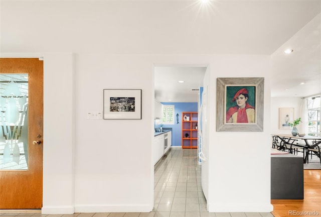 hall with recessed lighting, baseboards, and a healthy amount of sunlight