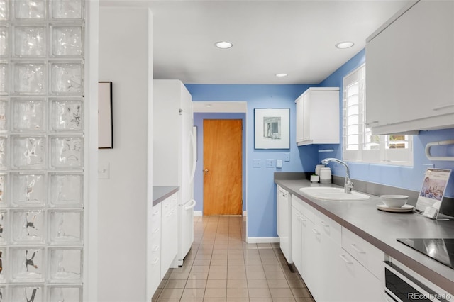 kitchen featuring a sink, white cabinetry, recessed lighting, light tile patterned floors, and baseboards