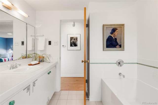 full bath with vanity, tile patterned floors, a garden tub, and tile walls