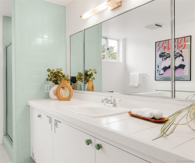 bathroom featuring an enclosed shower and vanity