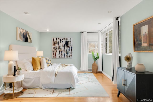 bedroom with recessed lighting, baseboards, and light wood finished floors