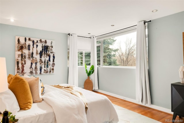 bedroom featuring light wood finished floors and recessed lighting