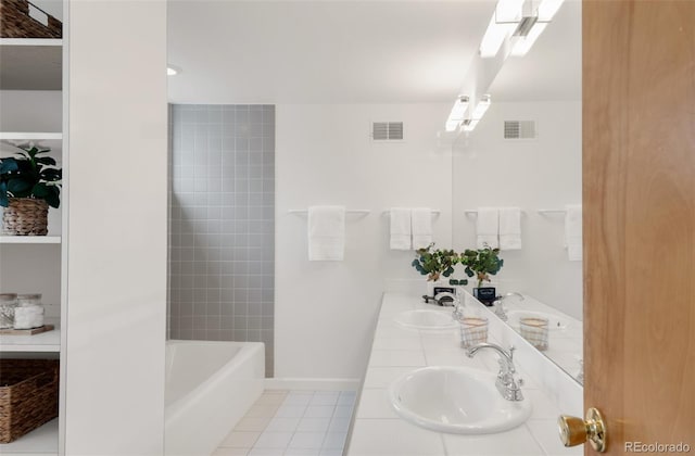 full bath with tile patterned floors, visible vents, and a sink