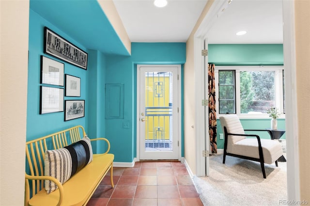 doorway with tile patterned flooring, electric panel, recessed lighting, and baseboards