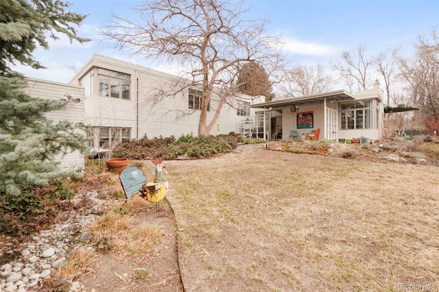 exterior space with a chimney and a front yard