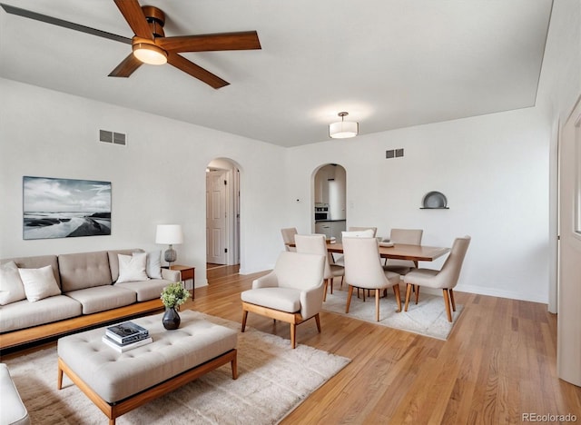 3050 S Delaware St, Englewood, CO 80110 - living room featuring arched walkways, a ceiling fan, and light wood-type flooring