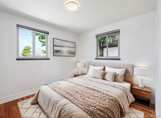 3050 S Delaware St, Englewood, CO 80110 - bedroom with multiple windows and wood finished floors