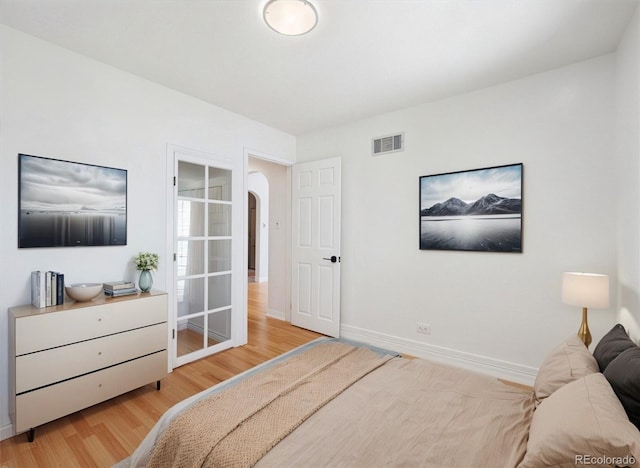3050 S Delaware St, Englewood, CO 80110 - bedroom featuring wood finished floors and arched walkways