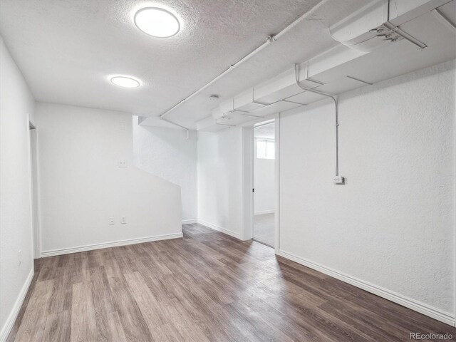3050 S Delaware St, Englewood, CO 80110 - basement featuring wood finished floors and a textured ceiling