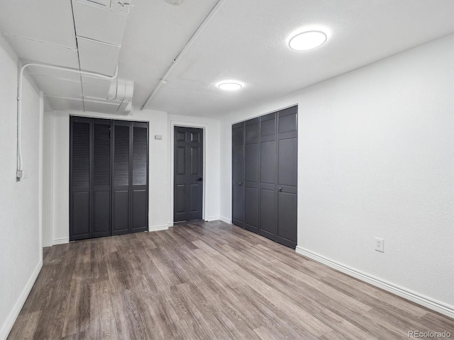 3050 S Delaware St, Englewood, CO 80110 - unfurnished bedroom featuring wood finished floors and baseboards