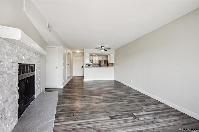 4273 S Salida Way Unit 1, Aurora, CO 80013 - unfurnished living room featuring a ceiling fan, a fireplace, dark wood-style floors, and baseboards