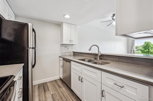 4273 S Salida Way Unit 1, Aurora, CO 80013 - kitchen with a sink, appliances with stainless steel finishes, wood finished floors, a ceiling fan, and white cabinets