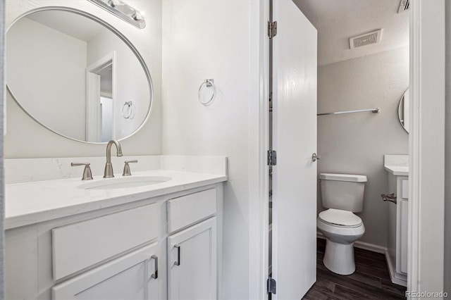 4273 S Salida Way Unit 1, Aurora, CO 80013 - bathroom featuring wood finished floors, toilet, vanity, and baseboards