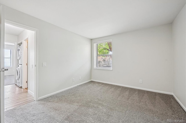 4273 S Salida Way Unit 1, Aurora, CO 80013 - spare room with stacked washer / dryer, carpet, and baseboards