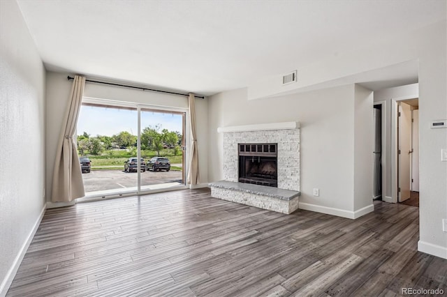 4273 S Salida Way Unit 1, Aurora, CO 80013 - unfurnished living room featuring wood finished floors, baseboards, and a fireplace