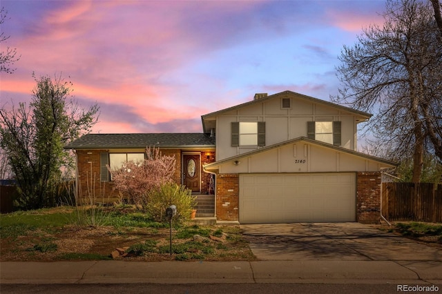 7140 S Reed Ct, Littleton, CO 80128 - tri-level home with brick siding and driveway