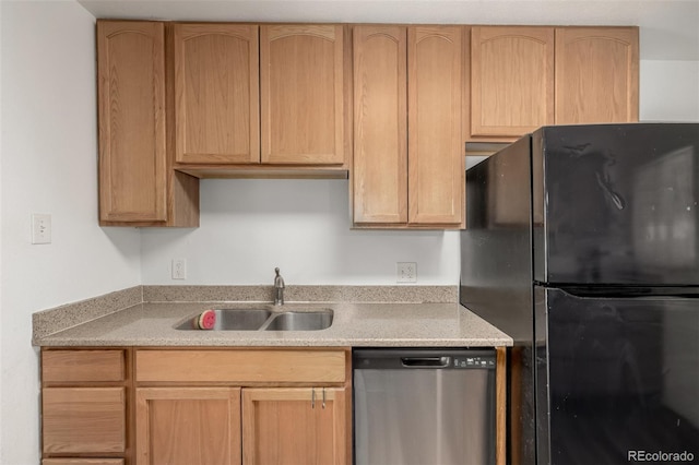 kitchen featuring a sink, stainless steel dishwasher, light brown cabinets, and freestanding refrigerator