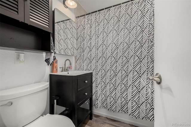 bathroom featuring a shower with shower curtain, toilet, and vanity