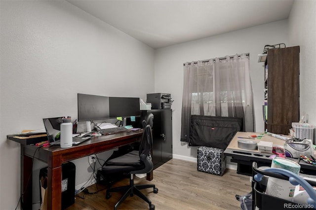 home office featuring baseboards and wood finished floors