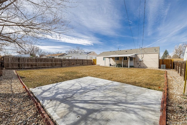 exterior space featuring central AC unit, a fenced backyard, and a patio area