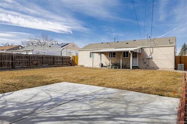 back of property featuring cooling unit, a lawn, a fenced backyard, and a patio area