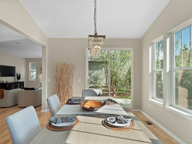 41 Garner Ln, Erie, CO 80516 - dining area with plenty of natural light, a chandelier, light wood-type flooring, baseboards, and vaulted ceiling