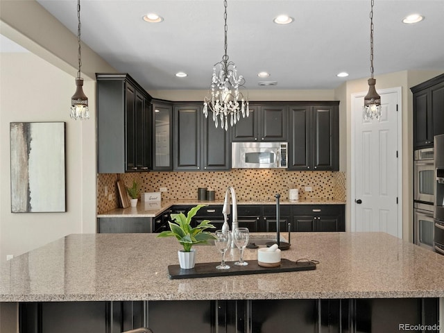 41 Garner Ln, Erie, CO 80516 - kitchen featuring appliances with stainless steel finishes, a sink, backsplash, hanging light fixtures, and recessed lighting