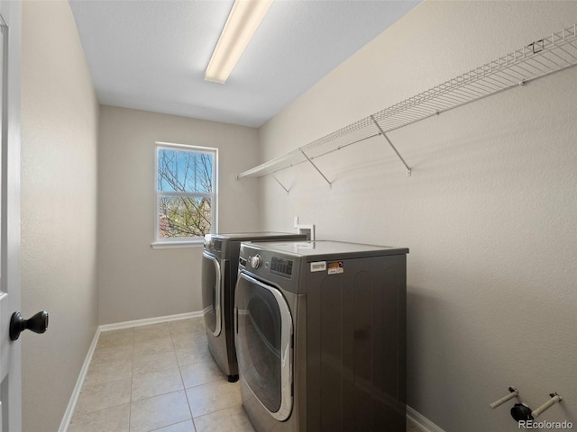 41 Garner Ln, Erie, CO 80516 - clothes washing area with washing machine and dryer, baseboards, and light tile patterned floors