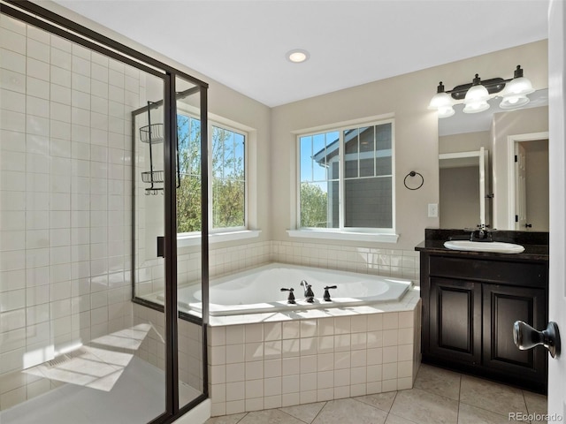 41 Garner Ln, Erie, CO 80516 - bathroom with tile patterned floors, a bath, a stall shower, vanity, and recessed lighting