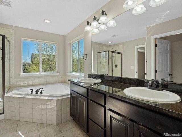 41 Garner Ln, Erie, CO 80516 - bathroom with a garden tub, a shower stall, tile patterned flooring, double vanity, and recessed lighting