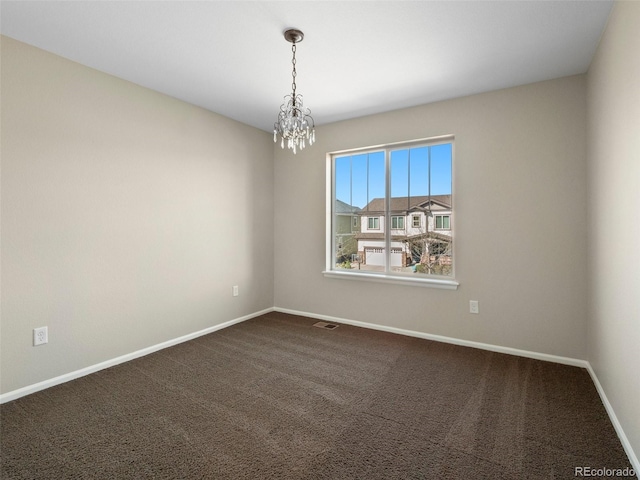 41 Garner Ln, Erie, CO 80516 - spare room with baseboards, a chandelier, and dark colored carpet