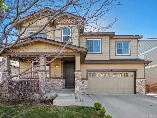 41 Garner Ln, Erie, CO 80516 - craftsman inspired home featuring an attached garage, stone siding, driveway, and a porch