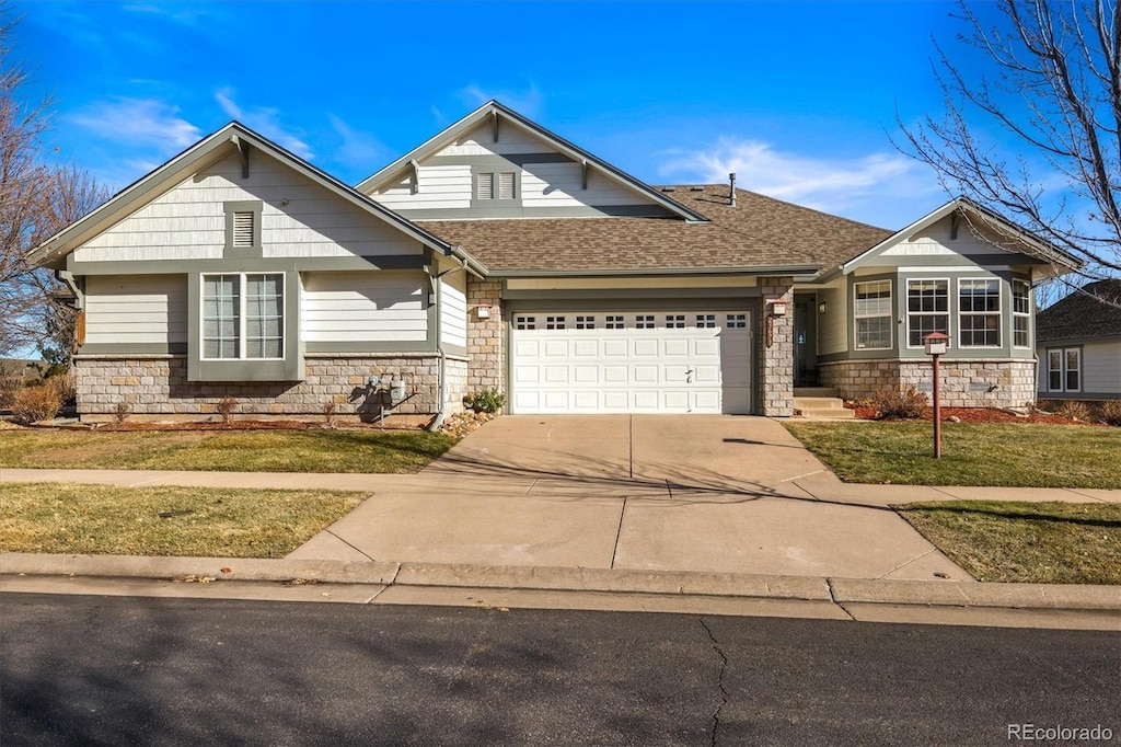 craftsman-style house featuring a front lawn and a garage