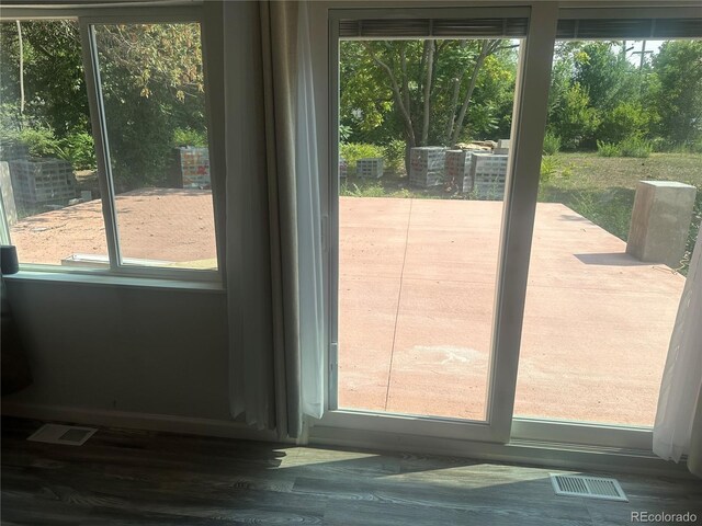 doorway to outside with visible vents and wood finished floors