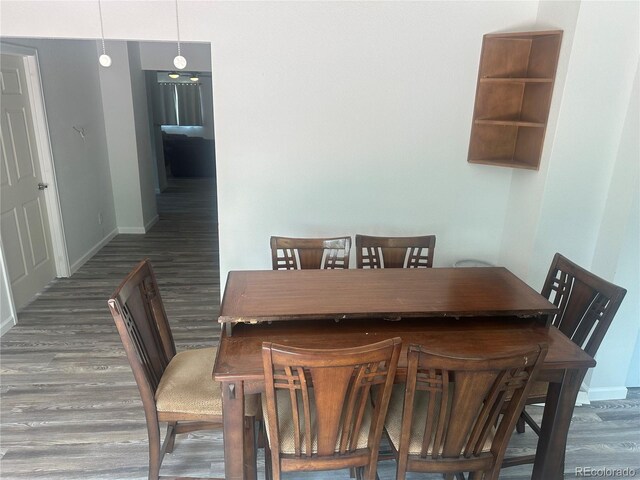 dining area featuring wood finished floors and baseboards