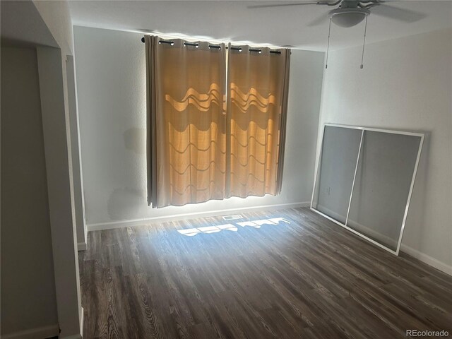 unfurnished room featuring baseboards, ceiling fan, and wood finished floors