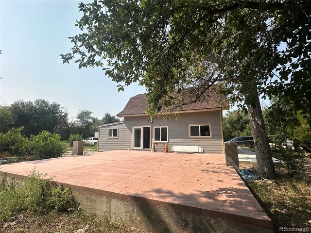 rear view of property featuring a patio area