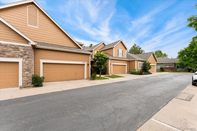 11705 W Stanford Ln, Morrison, CO 80465 - view of front of home featuring stone siding and a garage