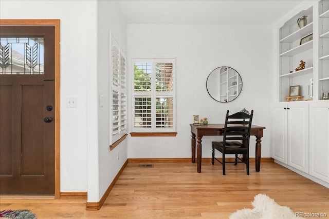 11705 W Stanford Ln, Morrison, CO 80465 - office featuring light wood-style flooring, baseboards, and built in shelves