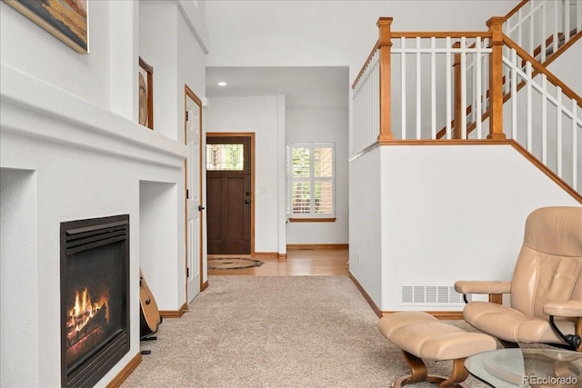 11705 W Stanford Ln, Morrison, CO 80465 - carpeted entrance foyer with a glass covered fireplace, baseboards, stairway, and recessed lighting