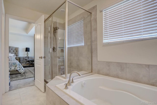 bathroom with independent shower and bath and tile patterned floors