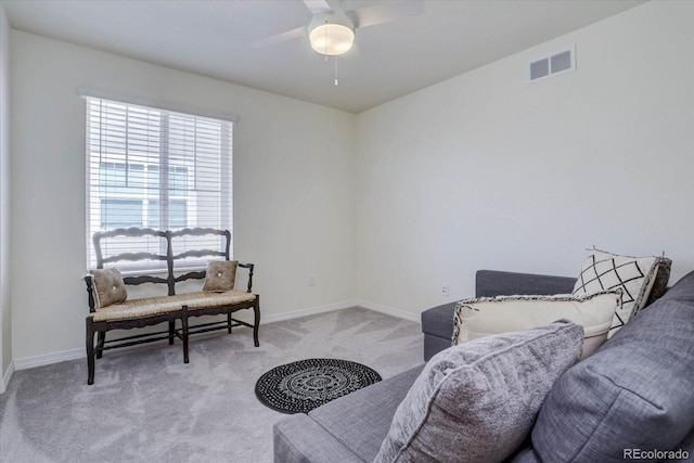 sitting room featuring ceiling fan and carpet