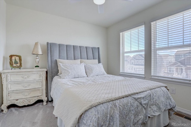 bedroom with light colored carpet and ceiling fan